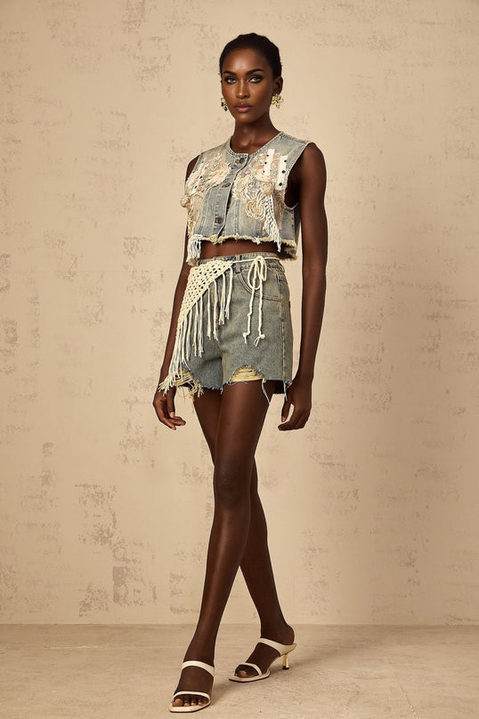 Amaryllis blue denim shorts with a boho style design worn by a model standing against a plain background