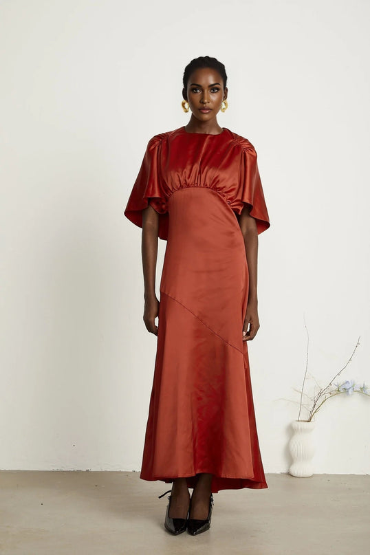 Amelina Red Satin Maxi Dress Crew Neck Cape Sleeves Gathered Detailing Fitted Waist Open Back Asymmetric Hem Rear Zip Fastening Viscose