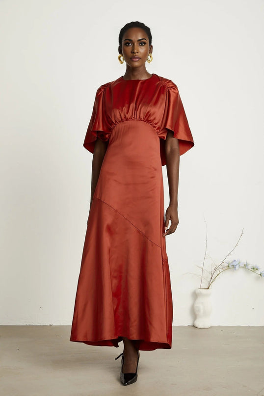 Amelina Red Satin Maxi Dress Crew Neck Cape Sleeves Gathered Detailing Fitted Waist Open Back Asymmetric Hem Rear Zip Fastening Viscose