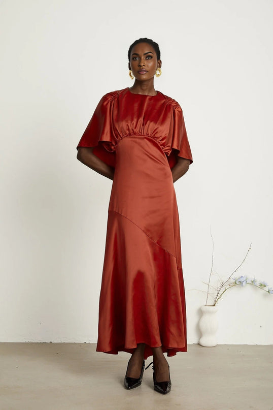 Amelina Red Satin Maxi Dress with Cape Sleeves Crew Neck Gathered Detailing Fitted Waist Open Back Asymmetric Hem Rear Zip Fastening 100% Viscose