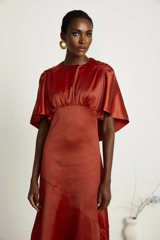 Amelina Red Satin Maxi Dress Crew Neck Cape Sleeves Gathered Detailing Fitted Waist Open Back Asymmetric Hem Rear Zip Fastening Viscose