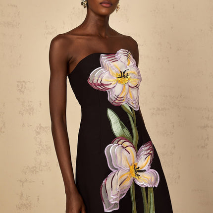 An offshoulder black midi dress with sequin embroidery details featuring a fitted silhouette and called the Irene dress