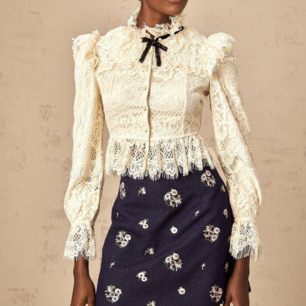 Anaelle blouse in off white featuring a bow detail and floral lace pattern