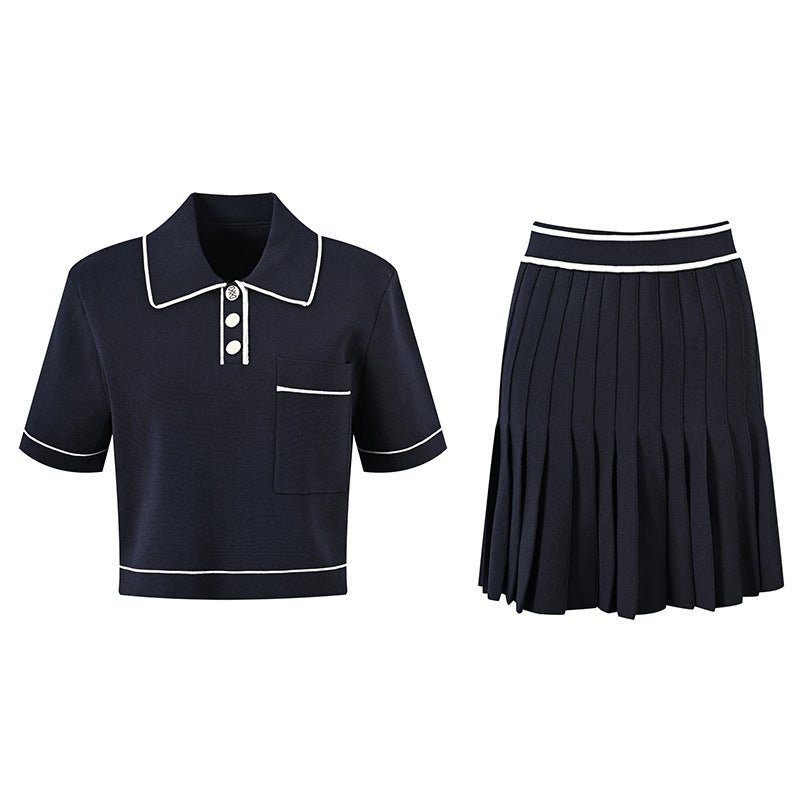 Anita wearing Black polo top with pleated skirt and white accents