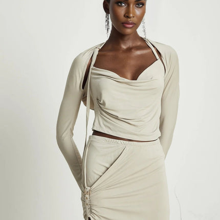 Annalisa Light Khaki Grey Skirt Top Set Matching Outfit Cupro Elastane Cowl Neck Long Sleeves Cut Out Design Adjustable Pin Buckle Halter Strap Low Rise Silhouette Gathered Effect Side Slit Gold Tone Buckle Fastening Decorative Knot Calf Length Hem