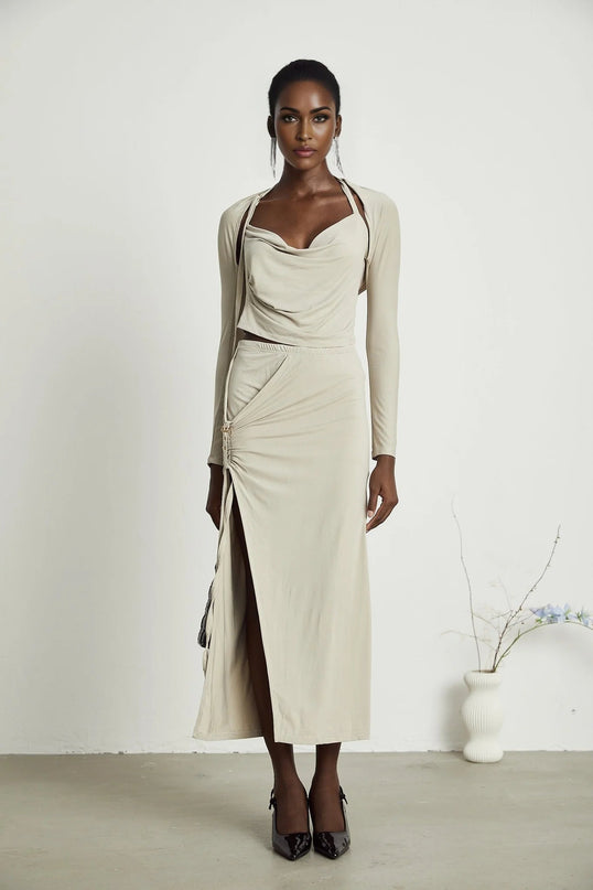 Annalisa Light Khaki Grey Skirt Top Set Matching Outfit Cupro Elastane Cowl Neck Long Sleeves Cut-Out Design Adjustable Pin-Buckle Halter Strap Low-Rise Silhouette Gathered Effect Side Slit Gold-Tone Buckle Fastening Decorative Knot Calf-Length Hem Modern Femininity Exquisite Ensemble