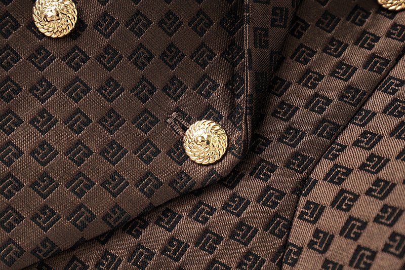 April wearing tailored double-breasted brown blazer with gold buttons and embossed geometric design