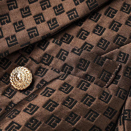 April wearing a tailored double-breasted brown blazer with gold buttons and embossed geometric design