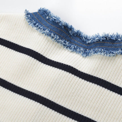 April wearing Multicolored striped cropped sweater with denim accents in Cream and navy, loose and comfortable fit for casual outings and weekend wear, retro-inspired and current fashion appeal