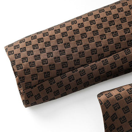 April wearing tailored double-breasted brown blazer with gold buttons in luxurious fabric