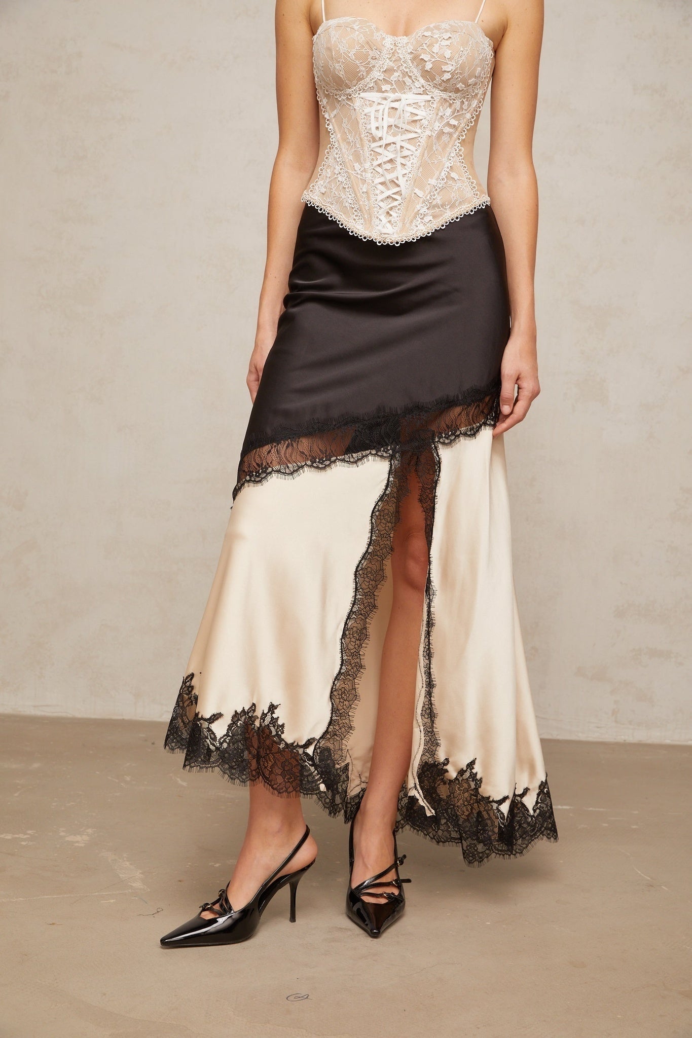 Asymmetric satin skirt with lace panel detailing named Raphaelle