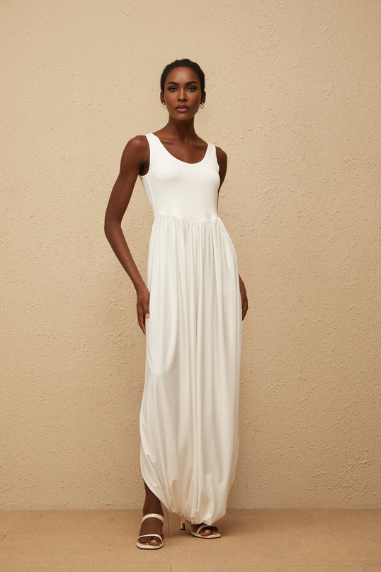 Barbara Maxi Dress in White Terylene Fiber Sleeveless Scoop Neck Wide Straps Fitted Waistline Pleated Skirt Side Slits Semi-Sheer Elegant Chic Modern Maxi Length