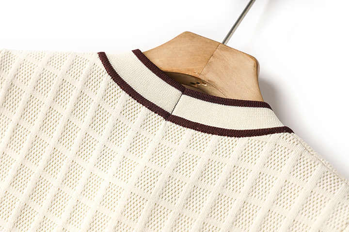 Beige knit A-line dress with brown piping and bow-tie detail