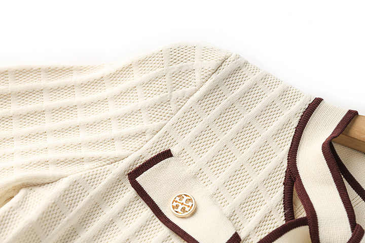 Beige knit A-line dress with contrast piping and bow-tie detail