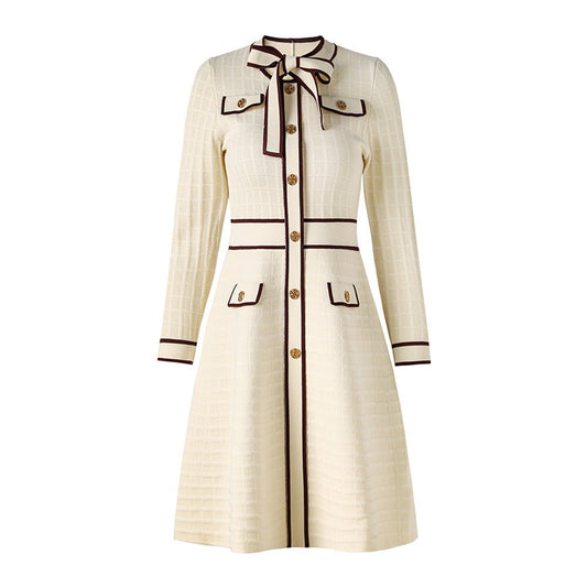Beige knit A-line dress with bow-tie detail and gold-tone buttons