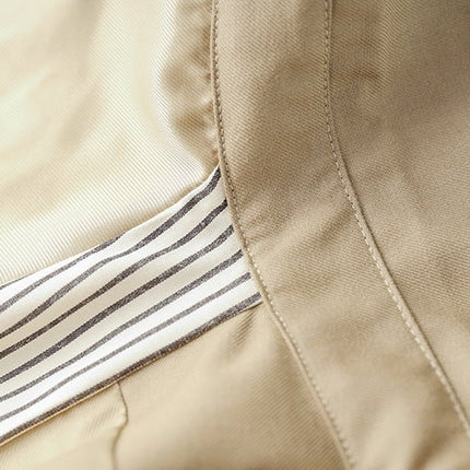 Beige oversized belted military-inspired jacket with epaulettes and adjustable cuffs