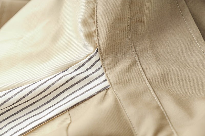 Beige oversized belted military-inspired jacket with epaulettes and adjustable cuffs