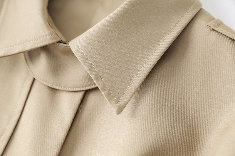 Beige oversized belted military-inspired jacket with epaulettes and adjustable cuffs
