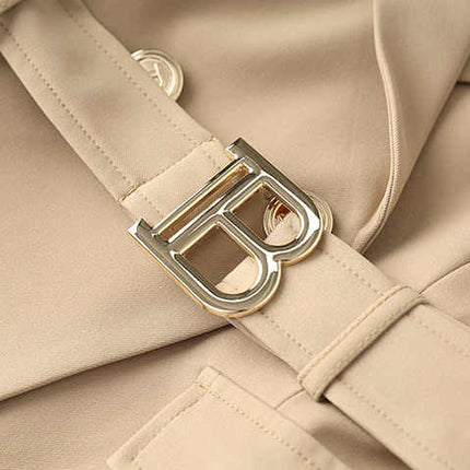 Beige tailored double-breasted blazer with gold button accents and belted waist