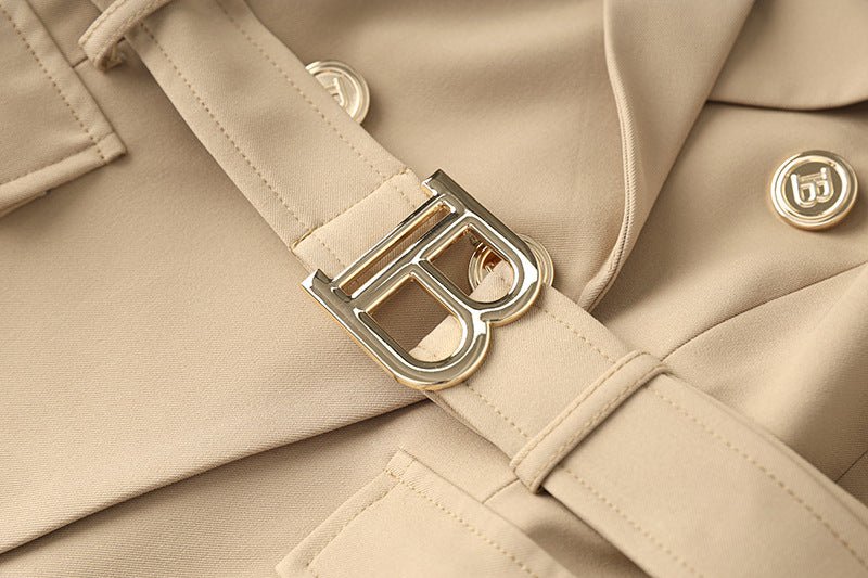 Beige tailored double-breasted jacket with gold button accents and belted waist