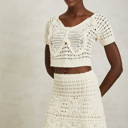 Bérénice Cream White Bowknot Knit Top crochet knit detail butterfly jacquard pattern ribbed hem cropped top luxurious blend cotton Terylene fiber style comfort tailored pants flowing skirt grace refinement