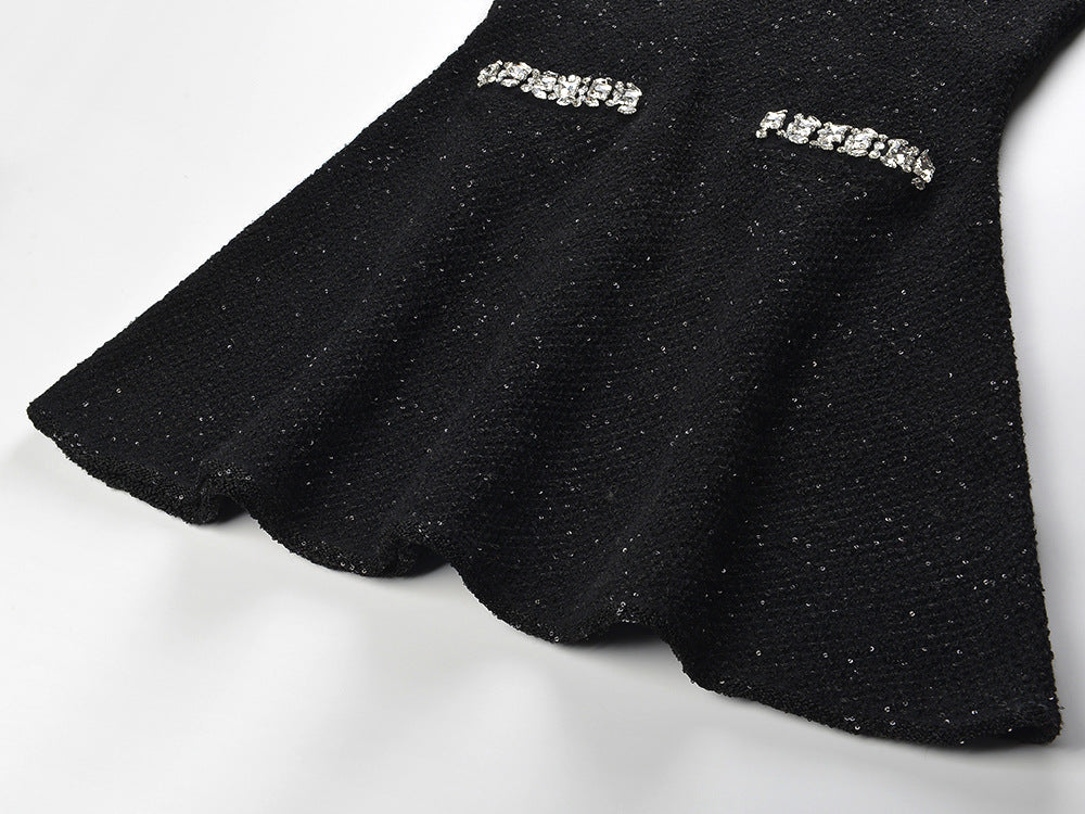 Black A-line dress with crystal details and jewelled accents on pockets