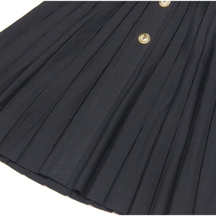 Black A-line dress with gold accents and pleated skirt