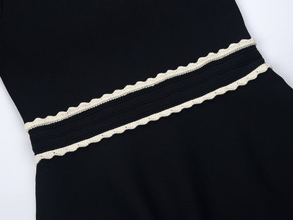 Black A-line silhouette dress with lace collar and puffed sleeves