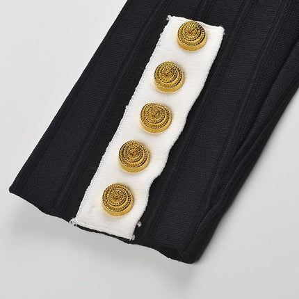 Black and white fitted peplum style top with vertical ribbed texture and gold button embellishments