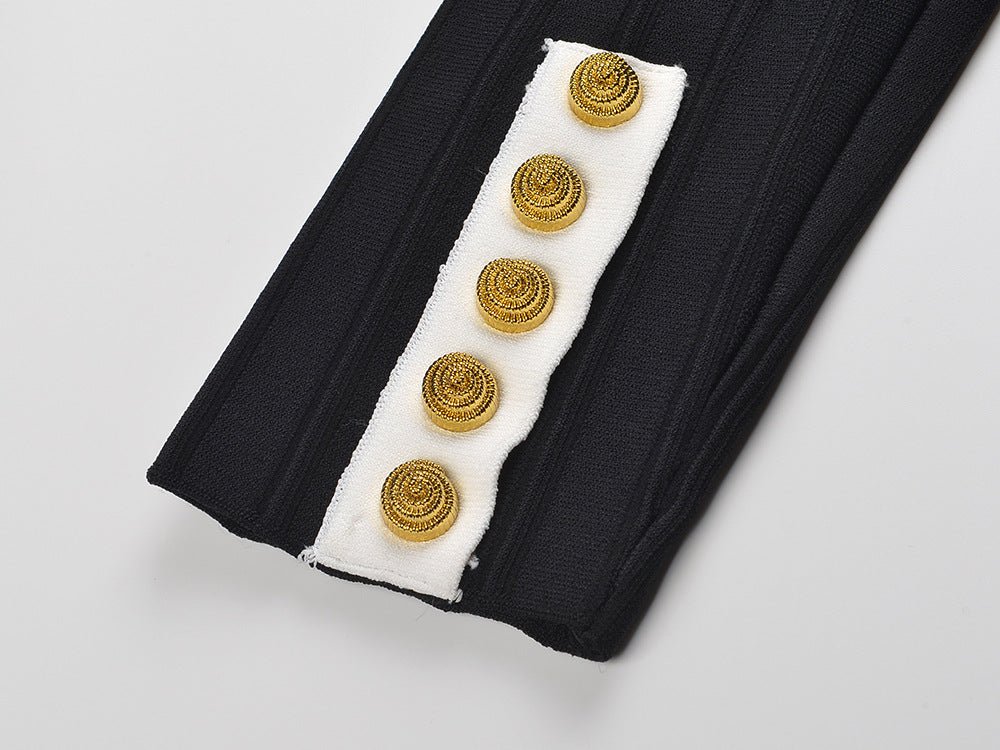 Black and white fitted peplum style top with vertical ribbed texture and gold button embellishments