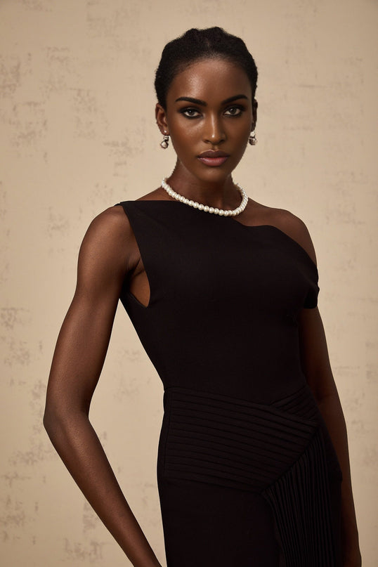 Black asymmetric draped midi dress with a flowing silhouette