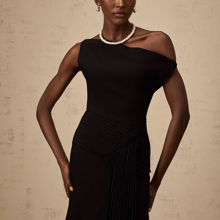 Black asymmetric draped midi dress with flowing fabric and uneven hemline