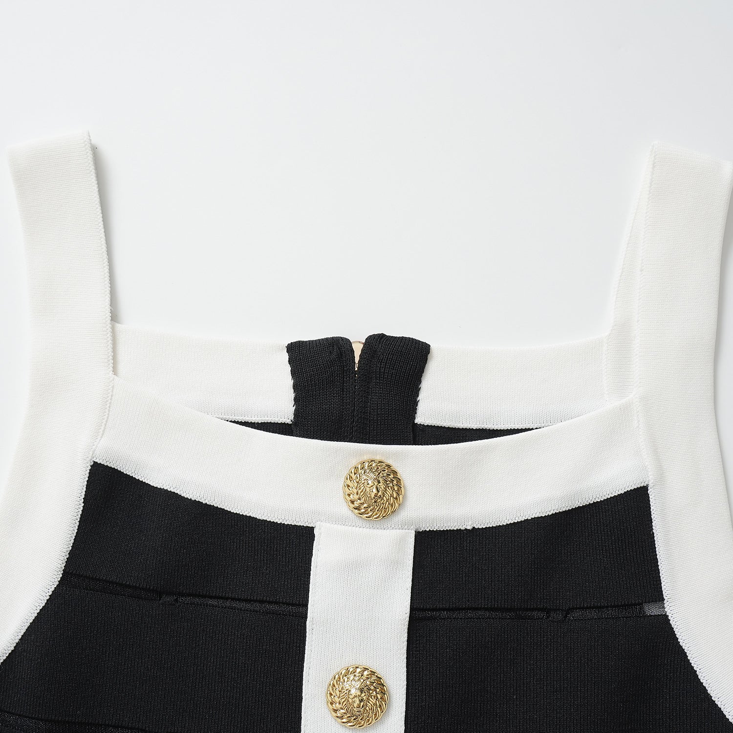 Black bodycon dress with white panel detailing and gold button embellishments