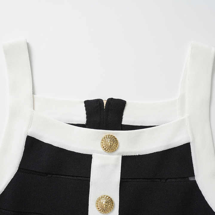Black bodycon dress with white panel detailing and gold button embellishments