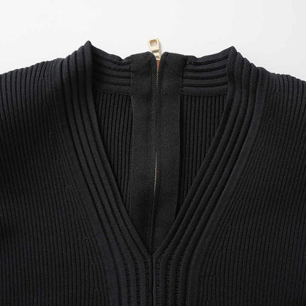 Black bodycon knit dress with flared hemline and gold button details