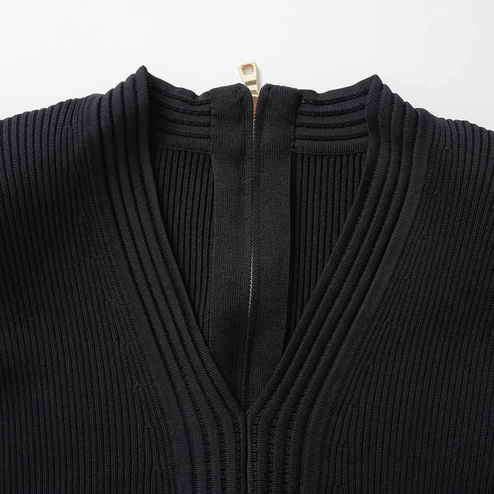 Black bodycon knit dress with flared hemline and gold button details