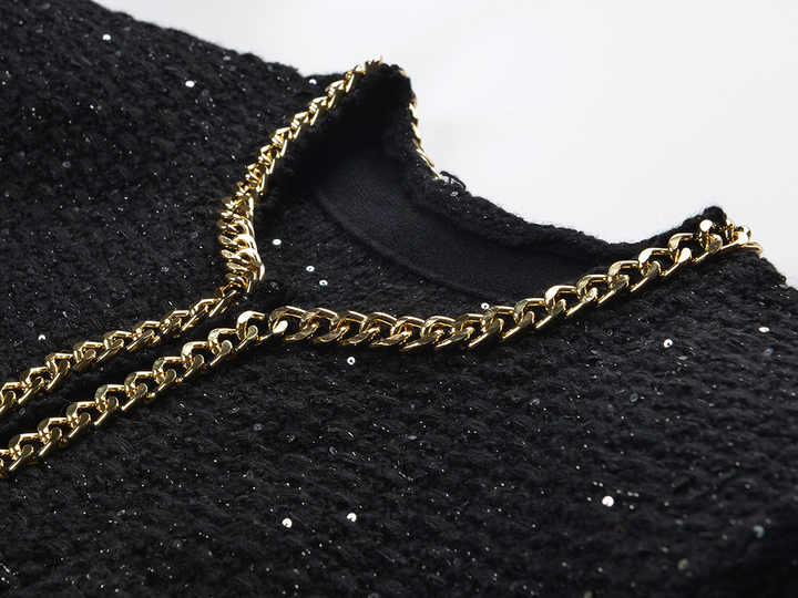 Black cropped boxy jacket with sparkling accents and gold chain trim