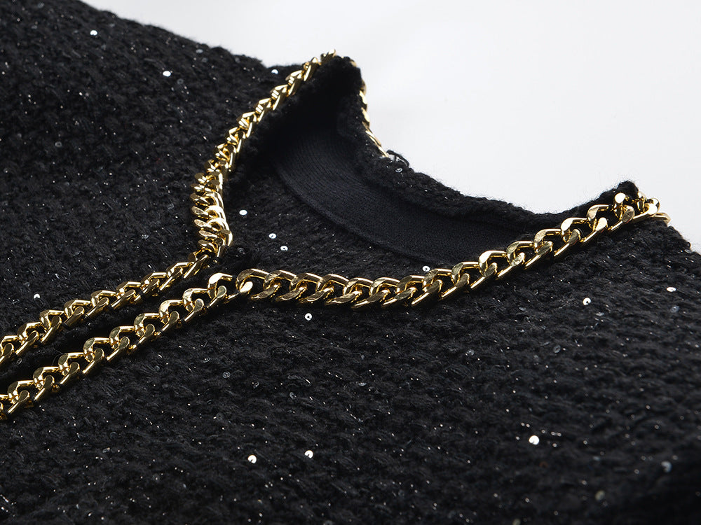 Black cropped boxy jacket with sparkling accents and gold chain trim