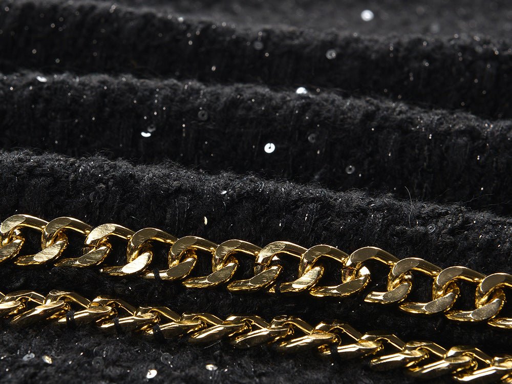 Black cropped boxy jacket with sparkling accents and gold chain trim