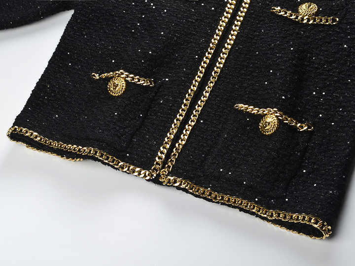 Black cropped boxy jacket with sparkling accents and gold chain trim