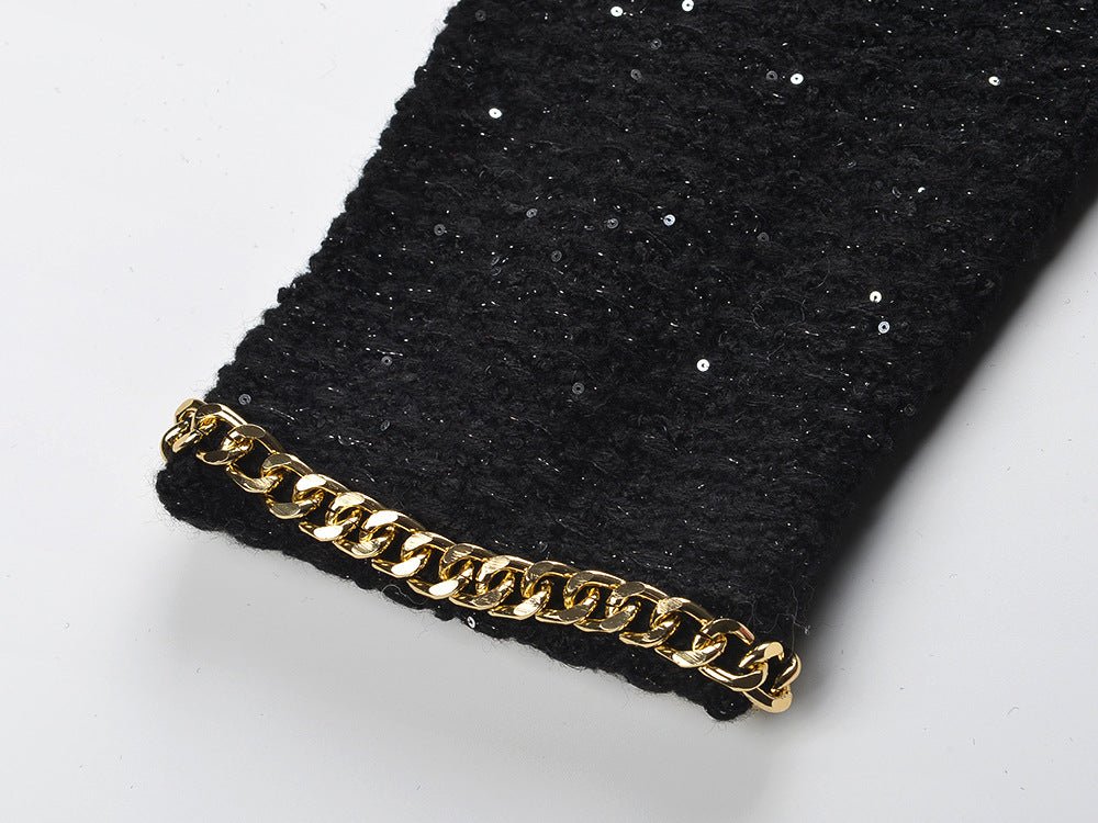 Black cropped boxy jacket with sparkling accents and gold chain trim