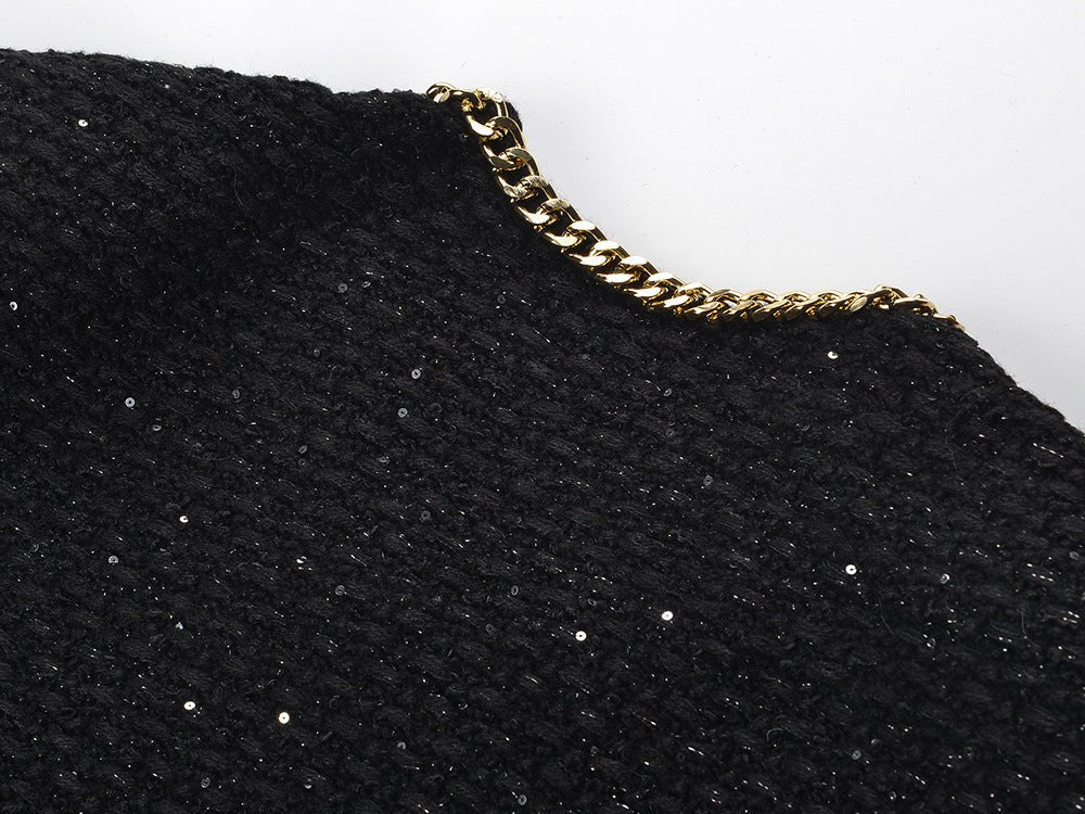 Black cropped boxy jacket with sparkling accents and gold chain trim