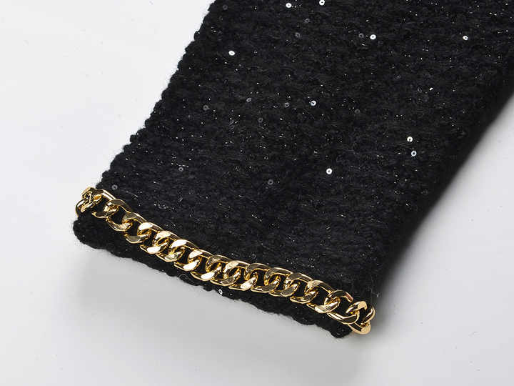 Black cropped boxy jacket with sparkling accents and gold chain trim