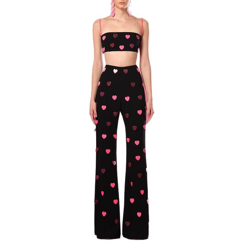 Black cropped top and flared pants with heart pattern and pink accents