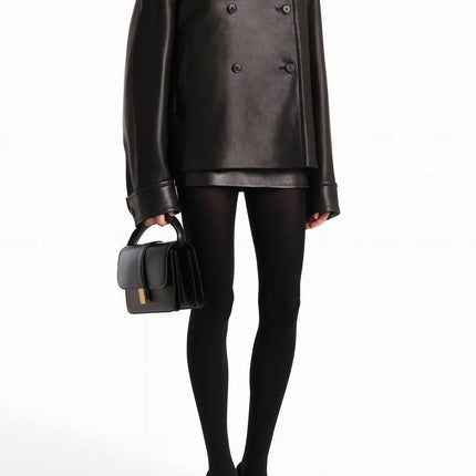 Laura wearing Black Dress Streetwear Style leather jacket with lamb fur accents and patchwork pattern