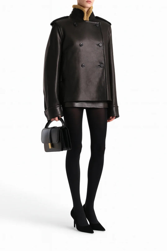 Laura wearing Black Dress Streetwear Style leather jacket with lamb fur accents and patchwork pattern