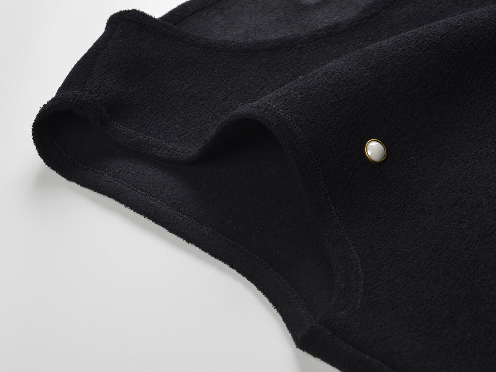 Black fitted bodice dress with pearl embellishments and ruffle hem