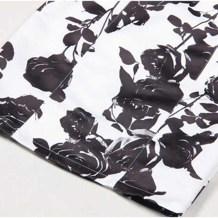 Black floral bodycon dress with halter neck on white background