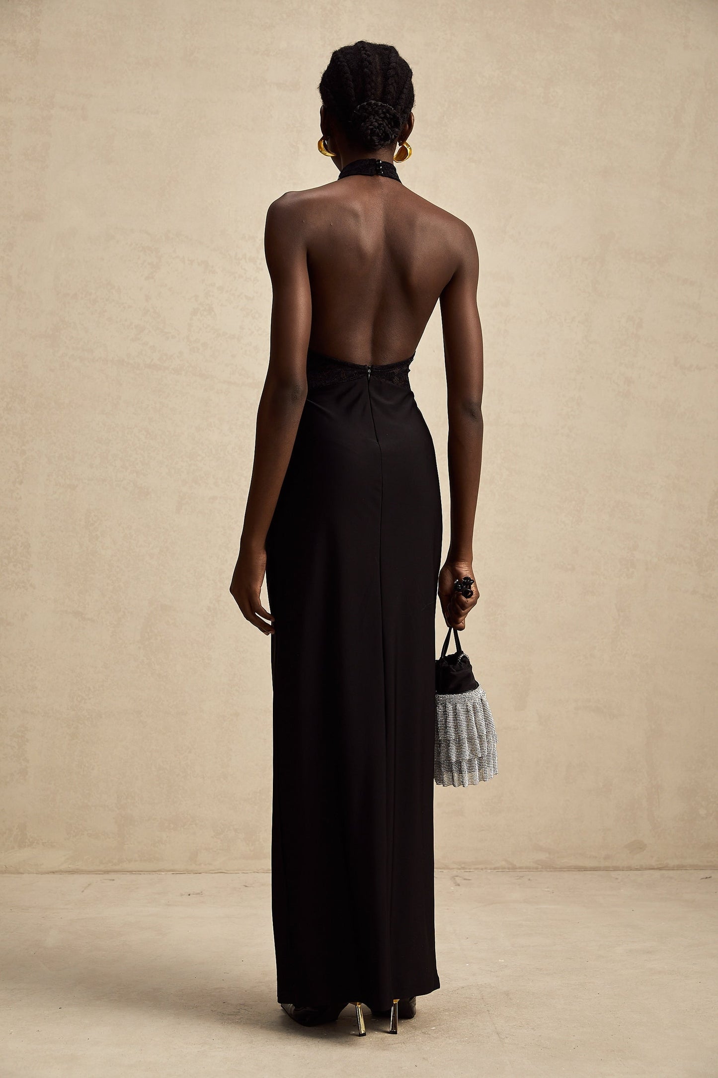 Black floral lace halter neck maxi dress named Camille featuring a long flowing skirt and delicate lace pattern