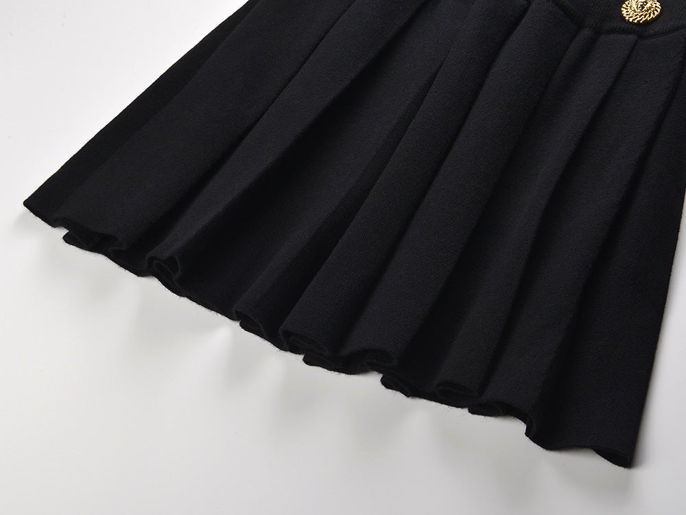 Black high-waisted pleated skirt with gold decorative buttons